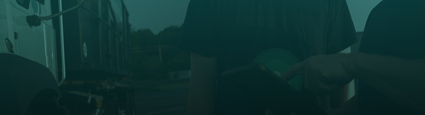 2 men talking in front of a truck. 