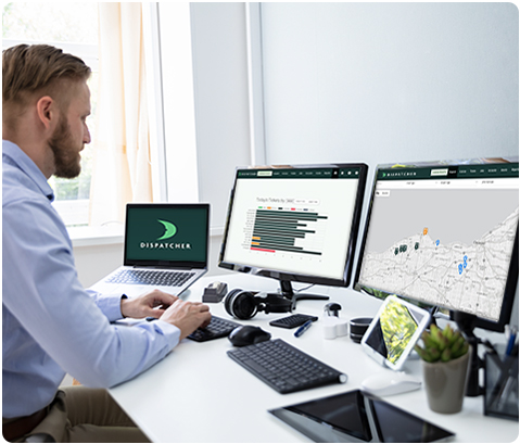 Man in Office with Laptop, Two Screens and Two Tablets